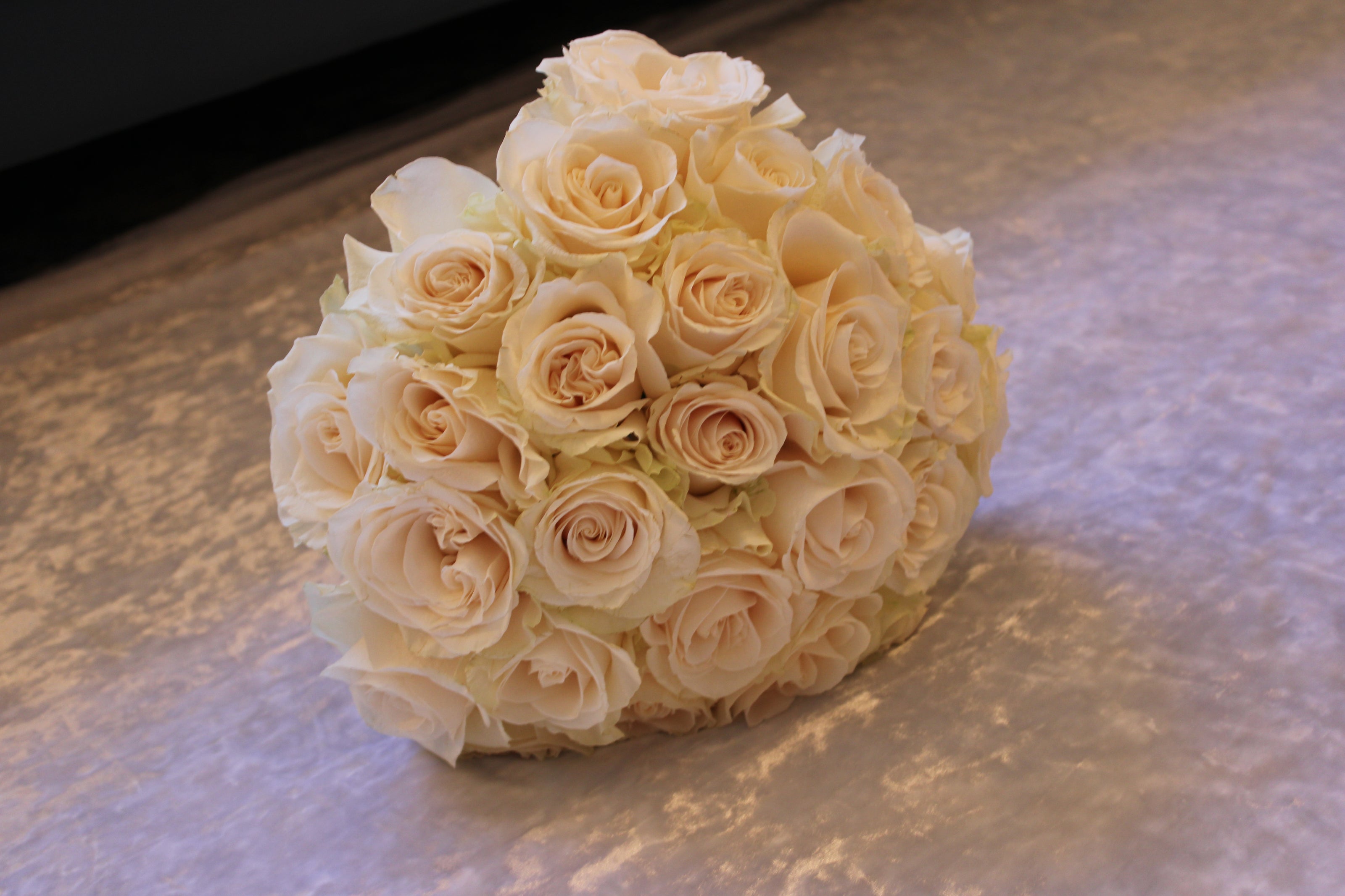 Modern-style two dozen cream roses proposal bouquet