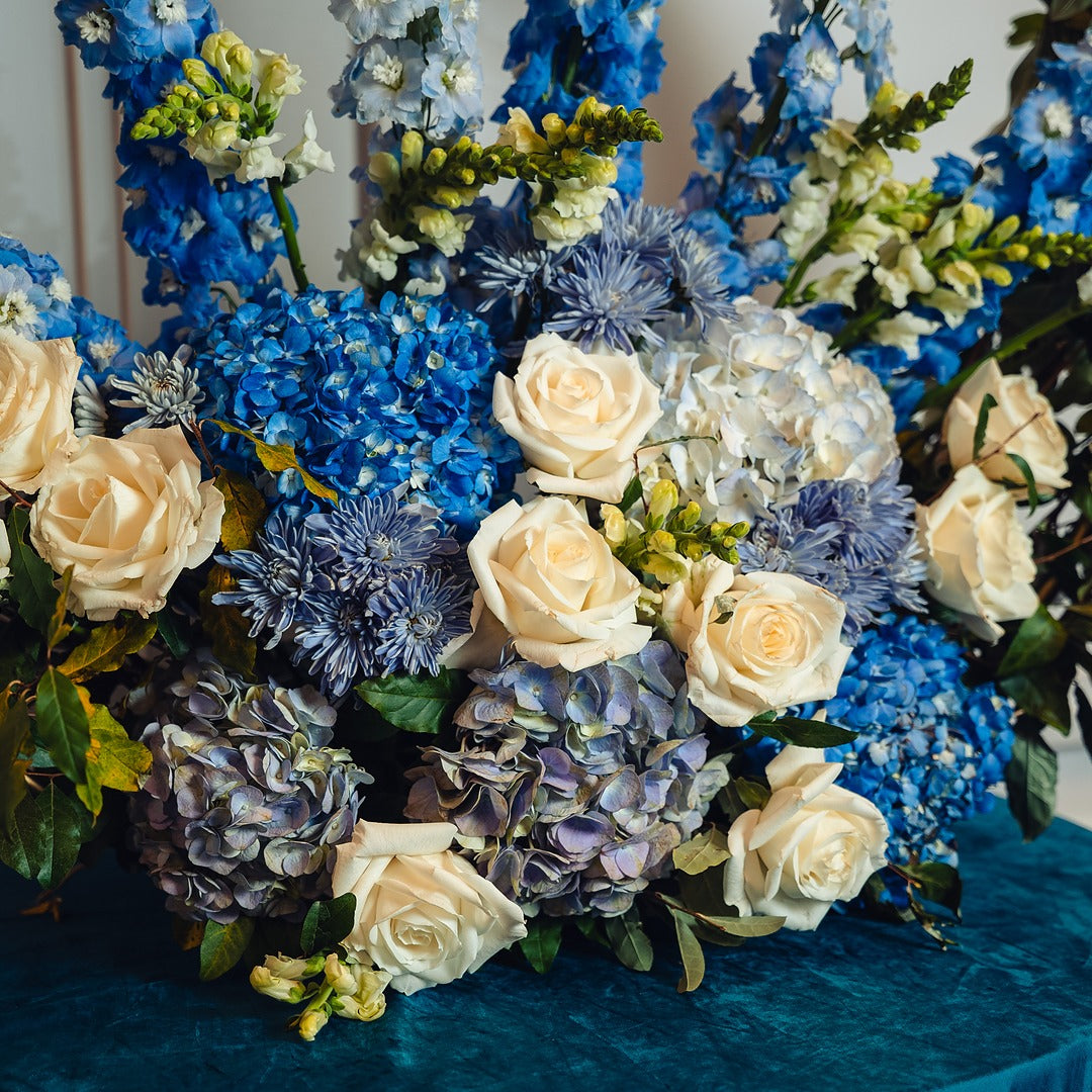 Close up of large blue and white floral arrangement for vort