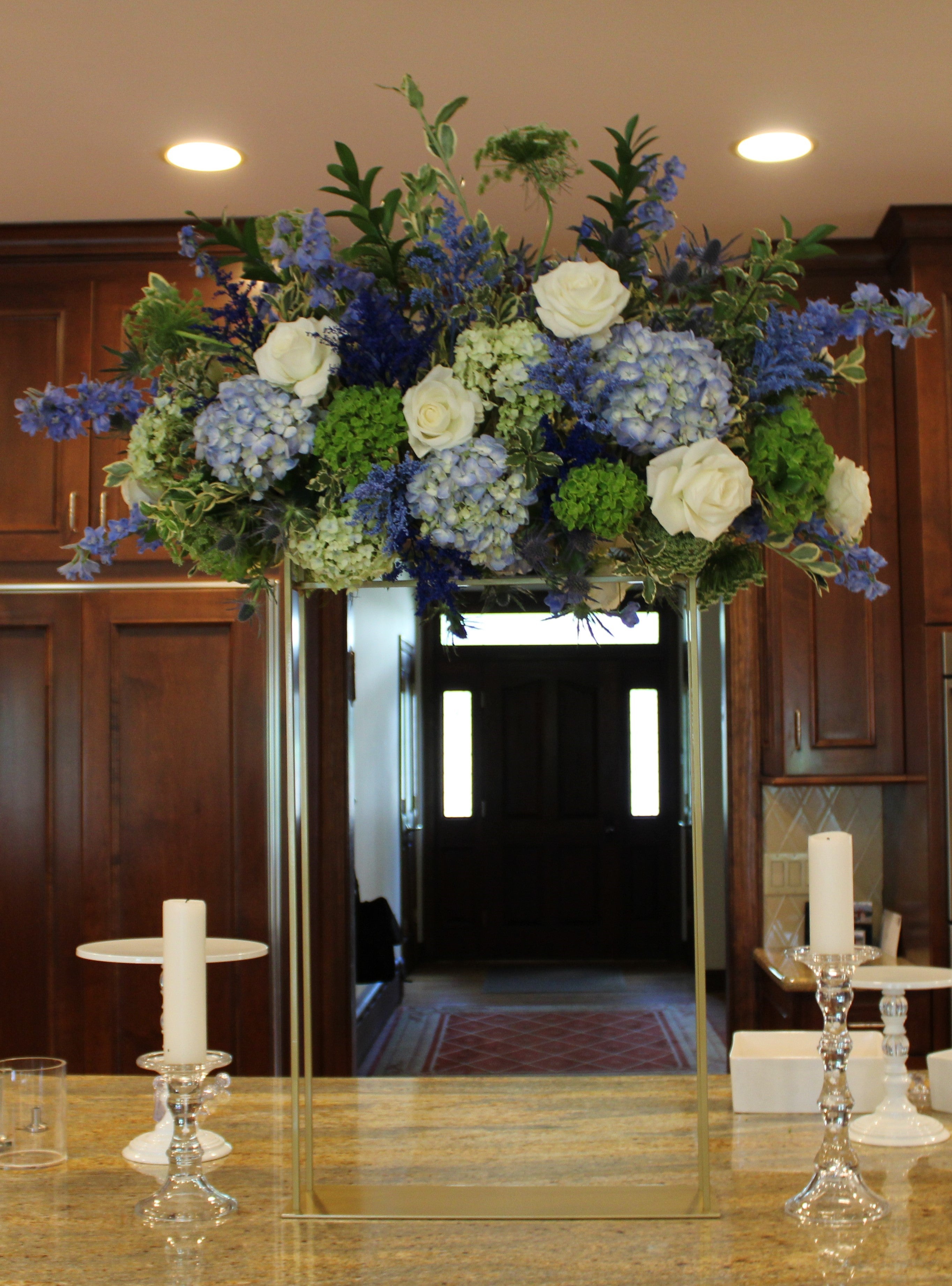 Chosson/vort centerpiece floral arrangement in shades of blue with green and white accents