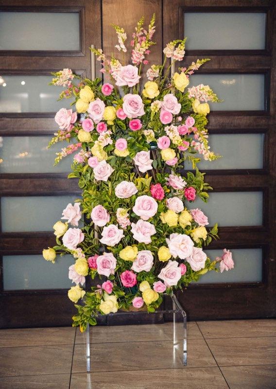 Chosson piece floral arrangement at a Vort with pink and green roses, pink ranunculus, snapdragons, and bright greenery on a stand