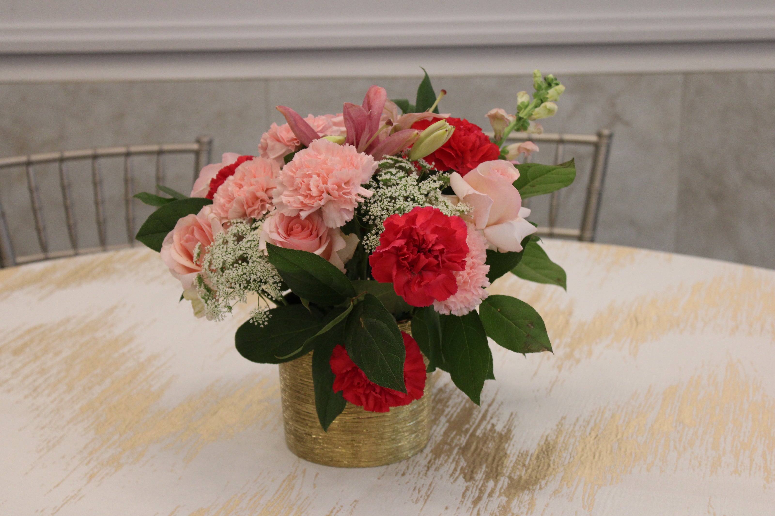 gold vase with pink and white florals round table centerpiece at vort