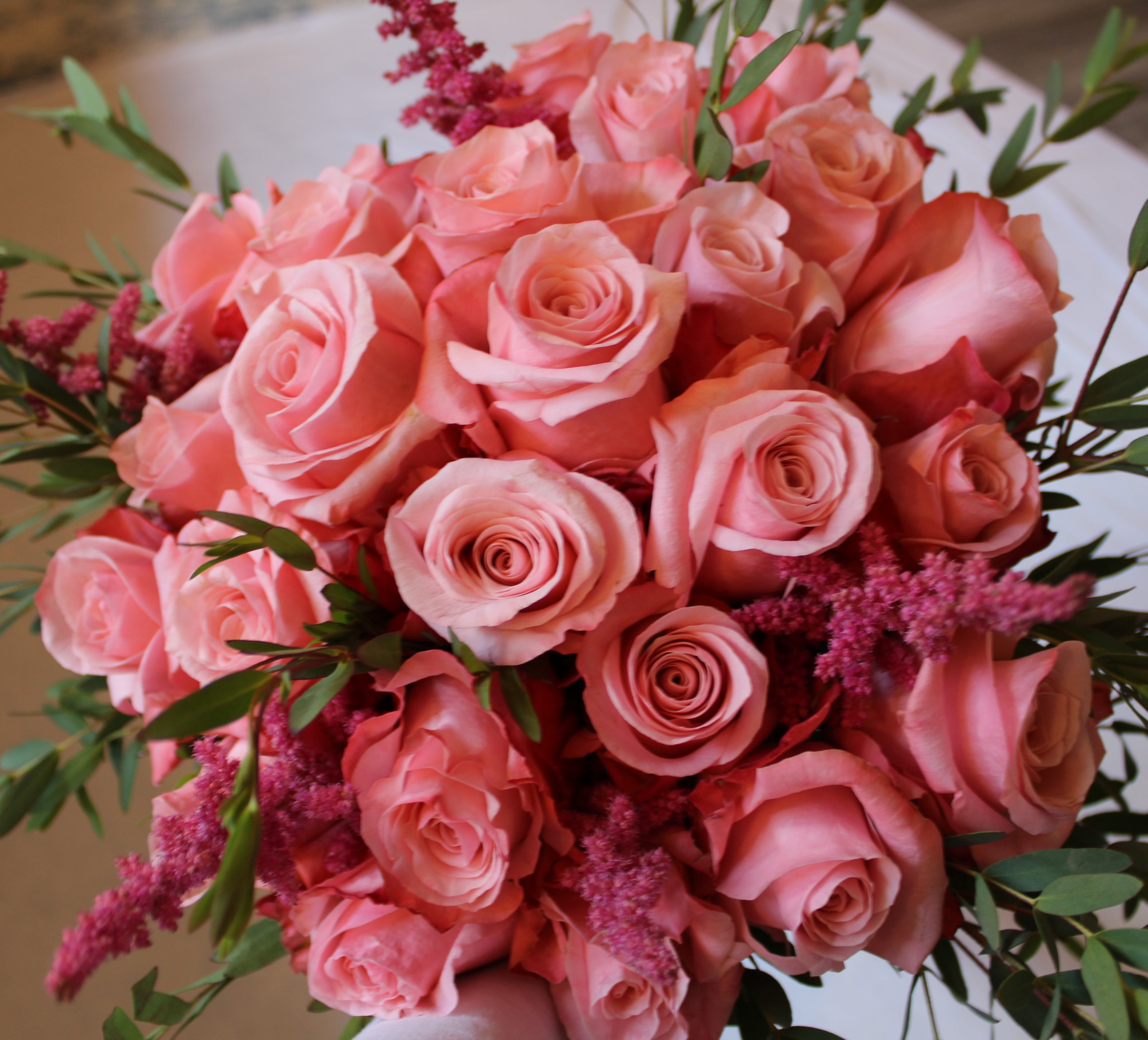 Round proposal bouquet of pink Be Sweet roses with eucalyptus and pink astilbe